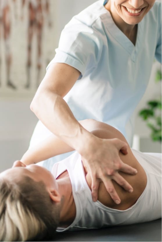 Woman getting shoulder stretched by a profressional